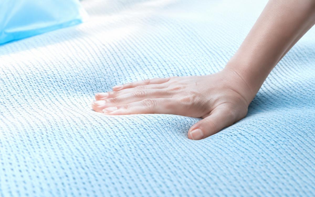 Hand pressing a breathable knit cooling mattress cover